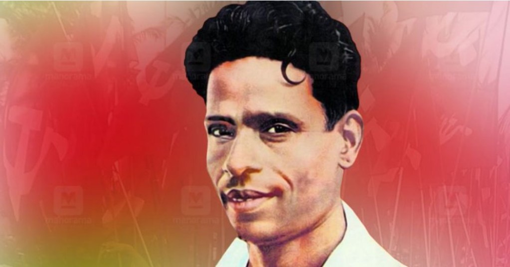 A portrait of a smiling man with dark, wavy hair against a soft red background.