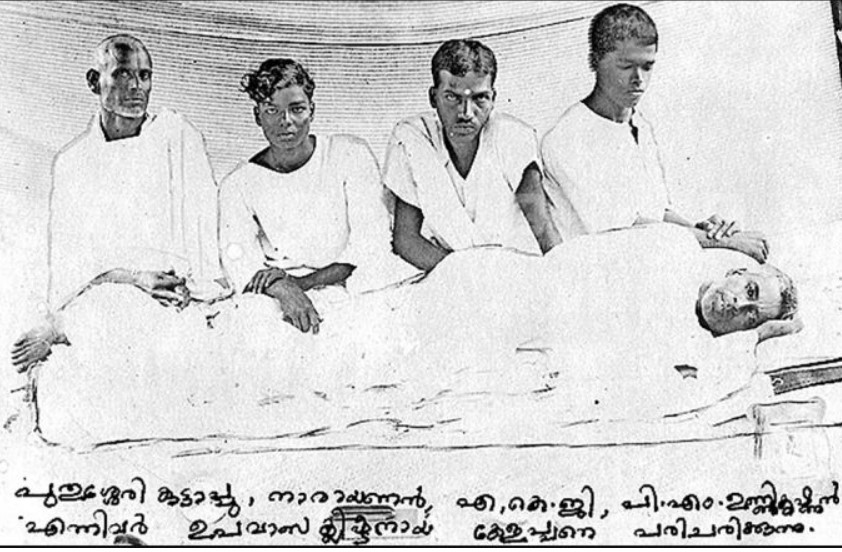 Historical photograph depicting four men in white clothing, with one man lying on a bed and the others standing or sitting beside him.